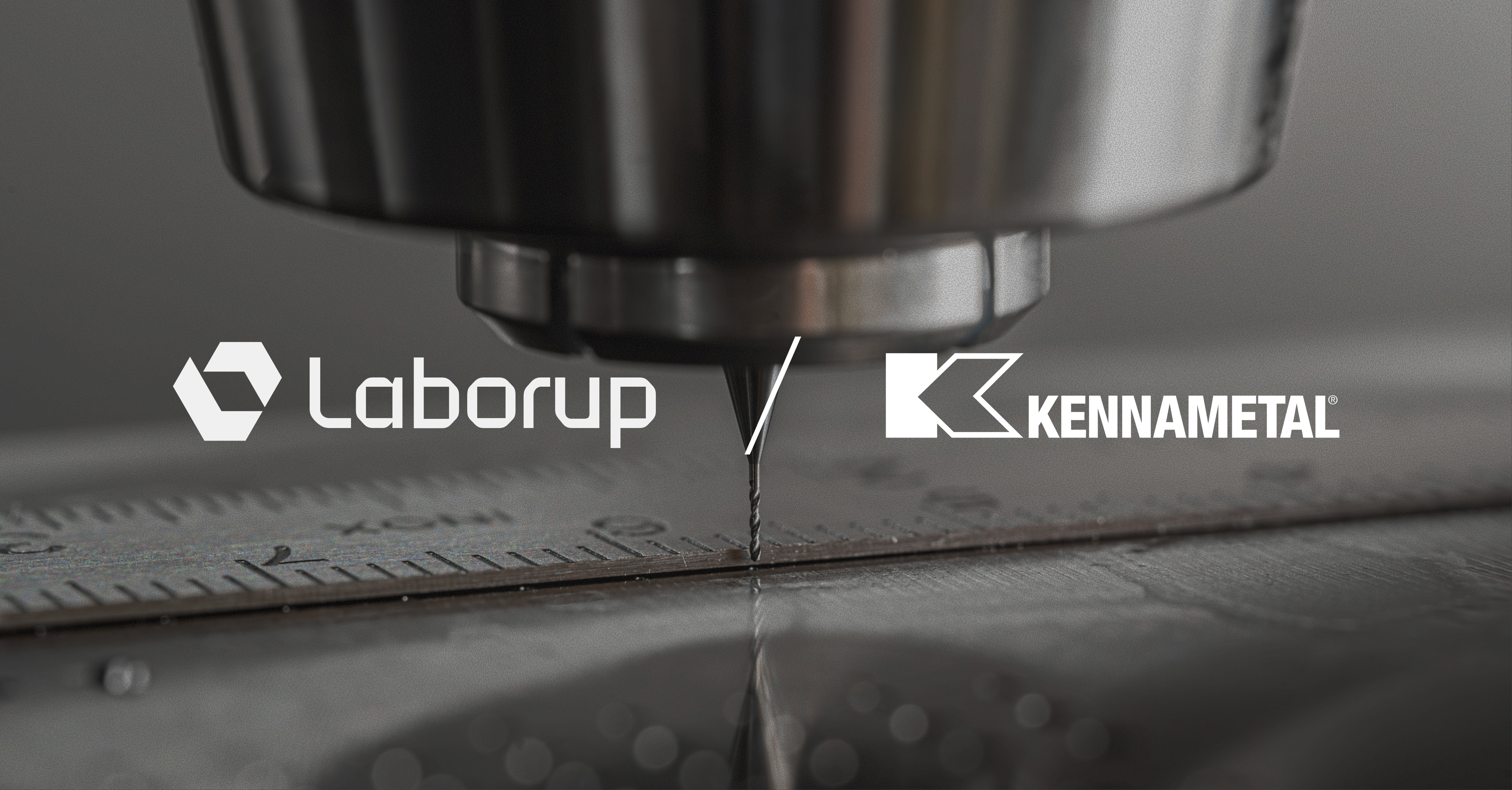 Laborup and Kennametal logos over a manufacturing operation